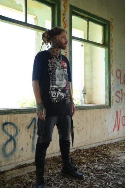 Uriel standing by a window in a weathered abandoned building